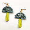 TWL vegan-friendly mushie earrings with blue metallic top and lime stem