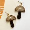 TWL vegan-friendly mushie earrings with metallic gold top and brown stem